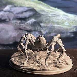 May include: A white, detailed, plastic miniature of a spider with eight legs and a round body. The spider is standing on a round, white base.