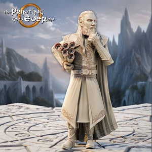 May include: A white miniature figurine of a man with a long beard, wearing a long robe and holding a stack of scrolls. The figurine is standing on a circular platform with a stone pattern.