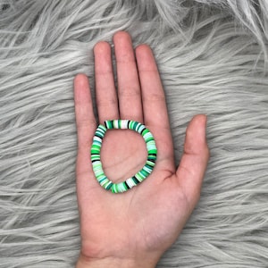 Green, black, and white clay bead friendship bracelets