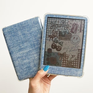 May include: A blue denim-textured e-reader case and cover. The e-reader screen displays a collage with the word "Howdy", an American flag, and other patriotic and floral graphics. The case is held open, revealing the screen.