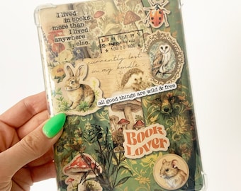 May include: A clear phone case with a collage of images and text. The images include a rabbit, an owl, a ladybug, a fox, mushrooms, and a mouse. The text includes "I lived in books more than I lived anywhere else." "LIBRARY AUG 20 1920" "currently lost in my kindle" "all good things are wild & free" and "Book Lover".