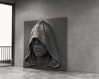 May include: A square wall art piece featuring a three-dimensional, dark gray relief sculpture of a human face partially obscured by a hooded cloak. The surface is composed of vertical, parallel lines that create a textured, layered effect.