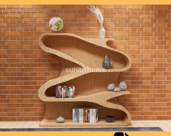 May include: A wooden CNC furniture file design for a unique, wavy bookshelf. The shelves are filled with books and decorative items. The text "CNC FURNITURE FILE" and "CUTTING READY DXF FILE" are displayed.