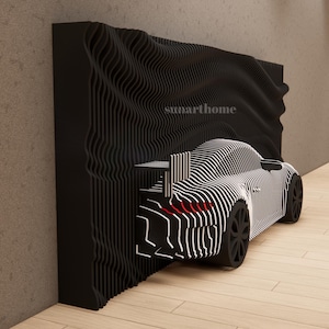 May include: A black and white striped car sculpture with a wavy black background. The car has black wheels and red taillights. The text "sunarthome" is visible on the background.