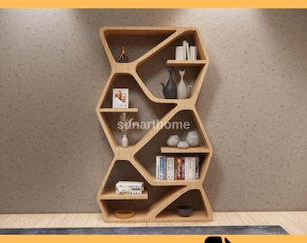 May include: A light-colored wooden bookshelf with an open, geometric design. The shelves hold decorative items like vases, books, and framed photos. The text "CNC FURNITURE FILE" and "CUTTING READY DXF FILE" are displayed.
