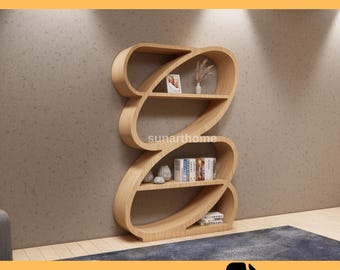 May include: A CNC furniture file for a wooden bookshelf with a unique, flowing design. The bookshelf has multiple shelves and is filled with decorative items and books. The text "CNC FURNITURE FILE" and "CUTTING READY DXF FILE" are displayed.