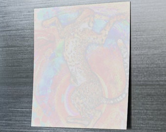 May include: A colorful abstract painting of a cheetah on a white background. The painting is attached to a stainless steel refrigerator with magnets.