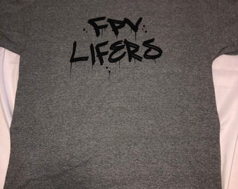 May include: A heather grey t-shirt with a black graphic print that says "FPV LIFERS" in a graffiti style.