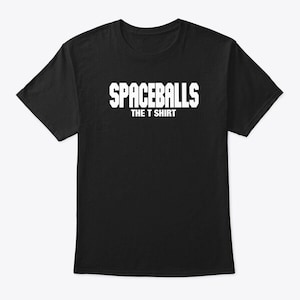 May include: Black t-shirt with the white text "SPACEBALLS THE T SHIRT" across the chest. The shirt is a crew neck style and appears to be made of a soft material. The text is in a bold, sans-serif font.