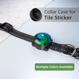 May include: A black collar with a gray stripe and a black plastic buckle. A round, blue, green, and black Tile Sticker case is attached to the collar. The text "Collar Case for Tile Sticker" is displayed above the collar. The text "Multiple Colors Available" is displayed below the collar.
