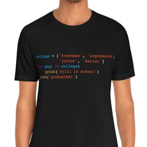 May include: Black t-shirt with a colorful Python code snippet about college years. The code includes terms like 'freshman', 'sophomore', 'junior', and 'senior'. The text also includes 'still in school' and 'graduated!'