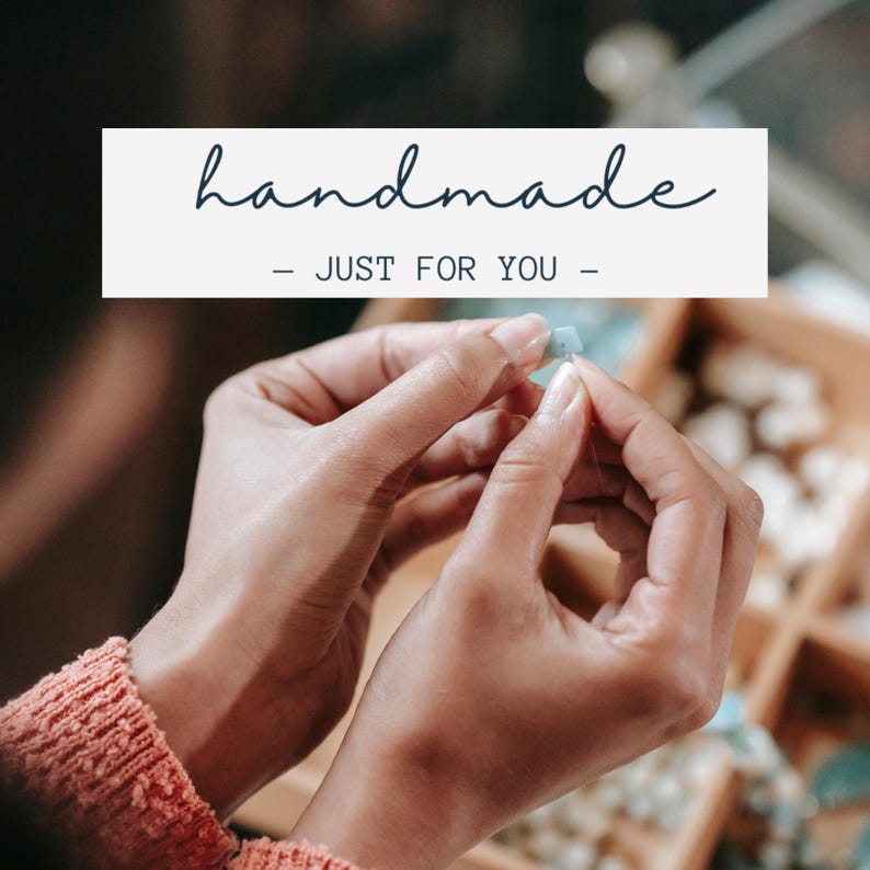 May include: A close-up shot of hands working on a piece of jewelry. The hands are holding a small, light blue bead and string. The text "handmade - JUST FOR YOU -" is displayed in a white rectangle at the top of the image. The person is wearing a coral-colored sweater.
