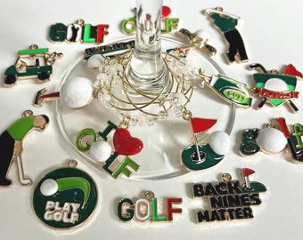 May include: A set of 12 gold-tone golf-themed wine glass charms. The charms feature various golf-related designs, including golf balls, golf clubs, golf carts, and the words "Golf", "Play Golf", "Back Nines Matter", and "I Love Golf".