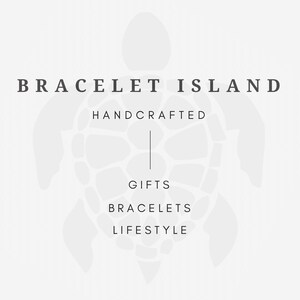 May include: A logo for Bracelet Island, featuring a turtle outline in light gray on a white background. The text reads "BRACELET ISLAND" above "HANDCRAFTED", "GIFTS", "BRACELETS", and "LIFESTYLE".