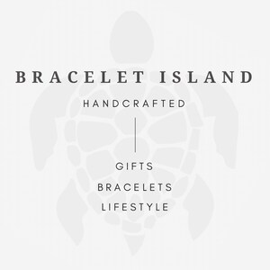 May include: A gray and white logo for Bracelet Island. The text reads "BRACELET ISLAND" above "HANDCRAFTED", "GIFTS", "BRACELETS", and "LIFESTYLE". A turtle graphic is in the background.