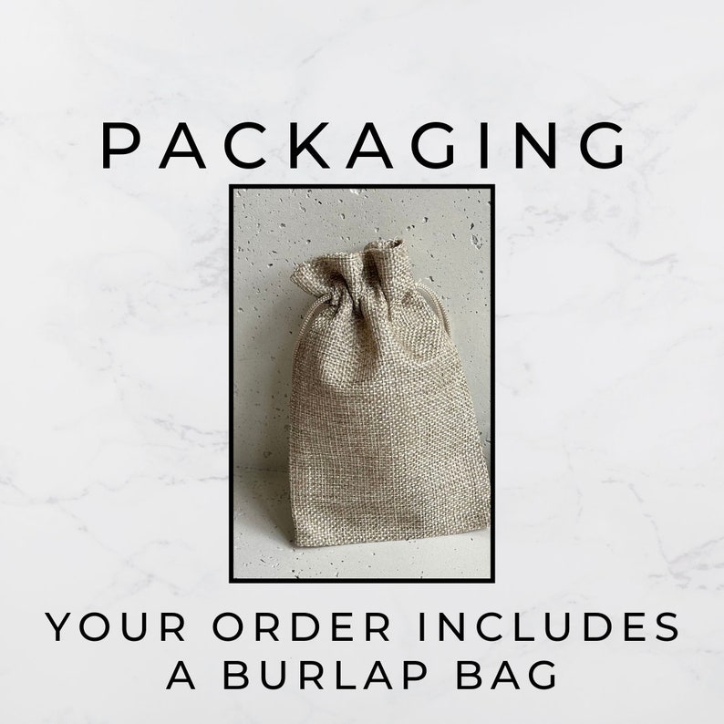 May include: A beige burlap bag with a drawstring closure. The bag is sitting on a white marble surface. The text "PACKAGING" is above the bag and the text "YOUR ORDER INCLUDES A BURLAP BAG" is below the bag.