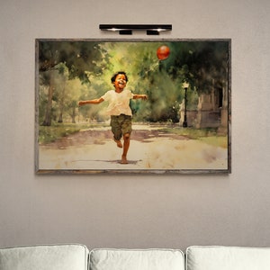 May include: A watercolor painting of a young person running through a park with a red balloon. The painting is framed in a wooden frame.