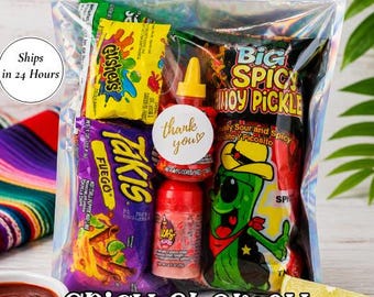 May include: A clear holographic pouch labeled Chamoy Pickle Kit containing a Big Spicy Chamoy Pickle, a bag of Takis Fuego, a pack of Gushers, a bottle of Lucas Gusano, and a bottle of Lucas Muecas, with a round white thank you sticker attached.