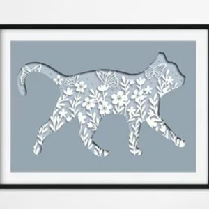 May include: A white silhouette of a cat walking, cut out of a light blue background. The cat is filled with a white floral pattern, including leaves, flowers, and butterflies.