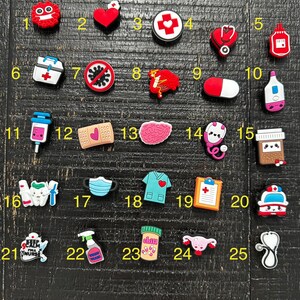 May include: Twenty-five colorful medical themed shoe charms. The charms include a heart, a first aid cross, a stethoscope, a pill bottle, a first aid kit, a no entry sign, a brain, a bandaid, a syringe, a thermometer, a mask, a doctor's scrubs, a clipboard, a pill bottle, a uterus, and a stethoscope.