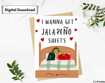 May include: A white card with the text "I wanna get jalapeño sheets" in black. The card features a cartoon bed with a green jalapeño and a red pepper in it. There are red hearts around the text and on the bed.