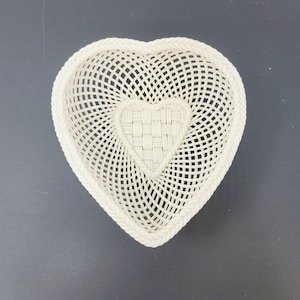 May include: A white heart-shaped woven basket with a smaller heart-shaped woven design in the center.