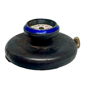 May include: A vintage compass with a black base and a blue and white enamel bezel. The compass face has black markings and a silver hand.