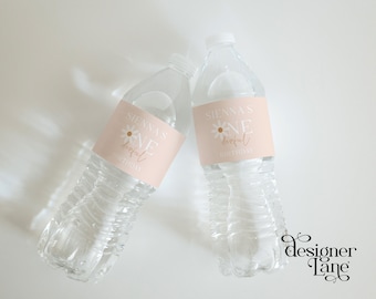 May include: Two clear plastic water bottles with pink and white labels that say "Sienna's One Derful Birthday".