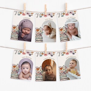 May include: A set of six baby milestone cards hanging on a string with wooden clothespins. Each card features a baby photo and text indicating the baby's age, with floral and book illustrations. The ages range from newborn to four months.