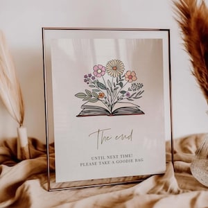 May include: A framed print with a floral illustration above the words "The End." The artwork features an open book with colorful flowers and greenery emerging from the pages. Below the text reads "UNTIL NEXT TIME! PLEASE TAKE A GOODIE BAG."