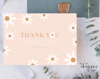 May include: A pink thank you card with white daisies and gold accents. The text reads "Thank You for celebrating Sienna's first birthday 14 April 2023".