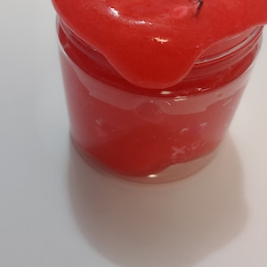 May include: A red slime with glitter in a clear glass jar.