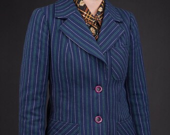 May include: A navy blue blazer with thin white and green stripes. The blazer has a notched collar, two flap pockets, and three buttons down the front.