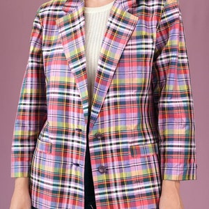 May include: A pink, red, yellow, green, and blue plaid blazer with a single button closure.