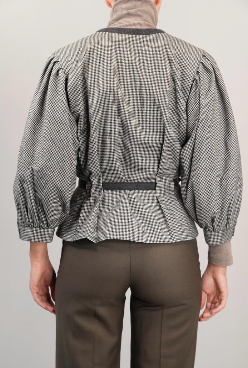 May include: A black and white gingham blouse with a cinched waist and puffed sleeves.