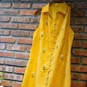 Hand-embroidered linen dress in vibrant yellow. Personalized, sleeveless, button-down – perfect for summer or gifting