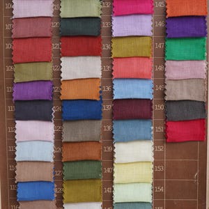 May include: A color palette featuring fabric swatches in a variety of hues, including pink, blue, green, and orange. Each swatch is rectangular and numbered, with a printed label at the bottom that reads "Colour palette."