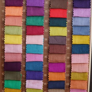 May include: A color palette featuring numerous fabric swatches in a variety of hues, including pinks, blues, greens, and browns. Each swatch is labeled with a number. The text "Colour palette" is visible at the bottom.