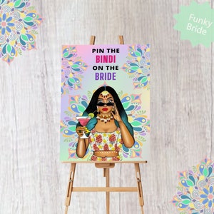 Könnte beinhalten: Ein farbenfrohes Spielbrett mit einer Cartoon-Illustration einer Frau, die ein Bindi, eine Sonnenbrille und ein traditionelles indisches Outfit trägt. Der Text auf dem Brett lautet "Pin the Bindi on the Bride".