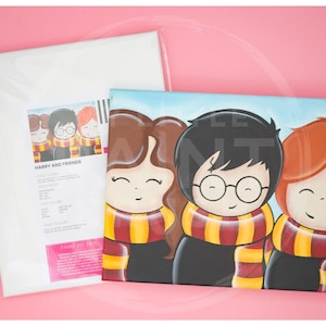 May include: A painting kit featuring a canvas with a cartoon illustration of Harry Potter and his friends, Hermione Granger and Ron Weasley. The characters are depicted in their Hogwarts school uniforms with their signature scarves. The title "Harry and Friends" is printed on the instruction sheet.