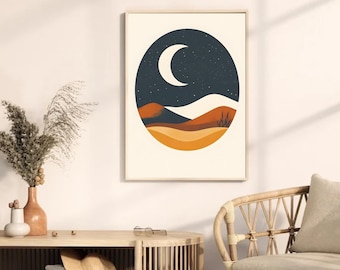 May include: A framed art print featuring a minimalist desert landscape with a crescent moon in a dark blue night sky. The artwork includes shades of orange, brown, and beige, creating a warm, earthy aesthetic. The print is displayed on a white wall.