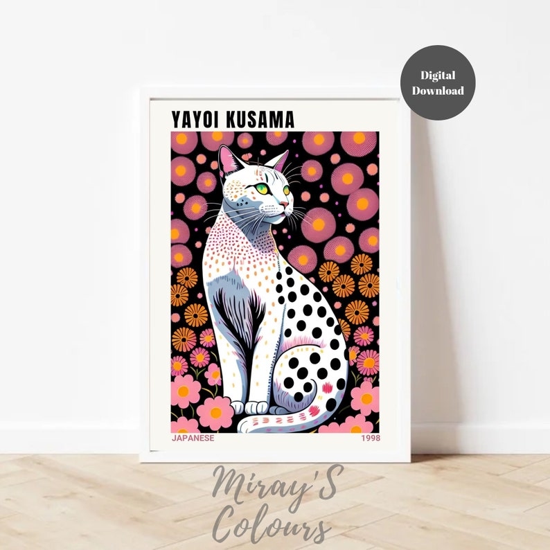 May include: A framed art print featuring a stylized white cat with black spots, green eyes, and pink ears. The cat sits against a backdrop of pink and orange flowers on a black background. The print includes the text "YAYOI KUSAMA" and "JAPANESE 1998".