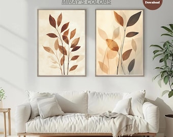 Può includere: Due stampe artistiche botaniche incorniciate con foglie marroni e beige su sfondo crema. Le stampe sono in una palette di colori neutri e sono etichettate "MIRAY'S COLORS" e "Digital Download". L'opera d'arte è esposta sopra un divano bianco.