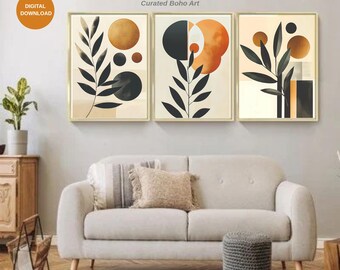 May include: Three framed abstract art prints with gold frames. Each print features a botanical design with black leaves and geometric shapes in shades of gold, orange, and black. The text "MIRAY'S COLORS" and "Curated Boho Art" are visible.