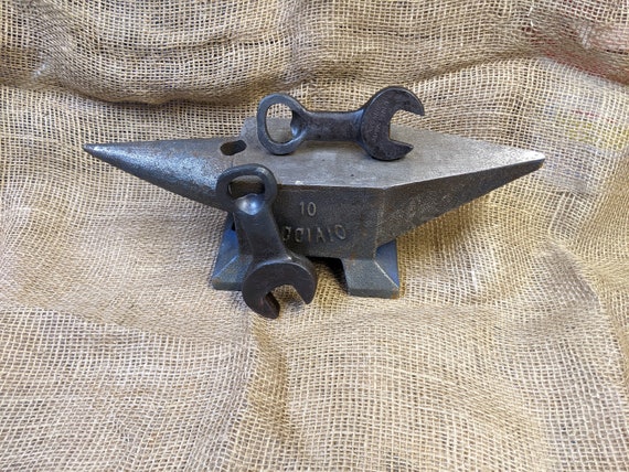A blacksmith-forged spanner wrench bottle opener — functional, industrial-cool, and you can feel the hammer marks in every use.