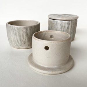 May include: A rustic wooden sign with the text "Welcome to our home" in white lettering. The sign features a distressed finish and a simple, inviting design, perfect for a front porch or entryway.