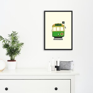 May include: A framed illustration of a green and yellow tram with the number 35 and the words "City Circle" on the front.