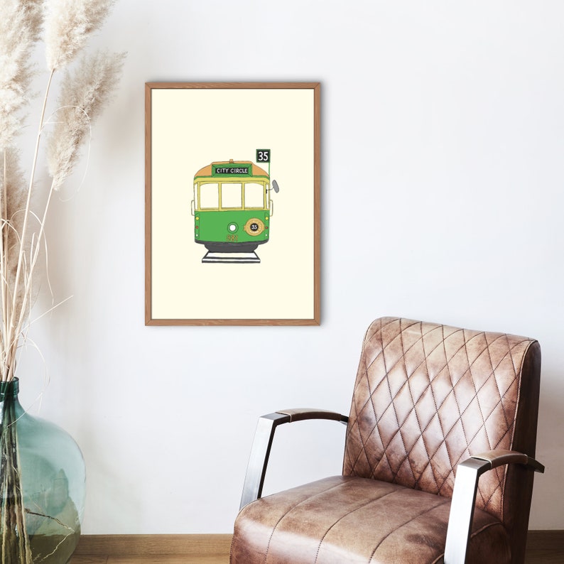 May include: A framed illustration of a green and yellow tram with the words "City Circle" and the number "35" on the side.