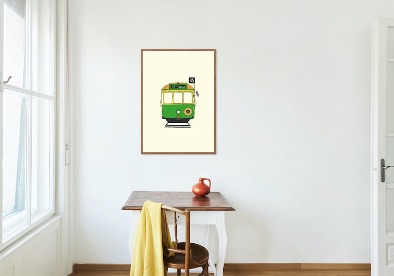 May include: A framed illustration of a green and yellow tram with the number 35 on the front. The tram is on a white background.