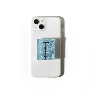 May include: A clear phone case with a square, blue and white graphic of a pool with a black diving board. The phone has a dual-lens camera and is set against a white background.